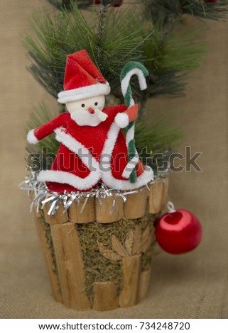 Santa Claus and Christmas Decor Toy Fir Tree Ball on Sackcloth Background Vertical Picture