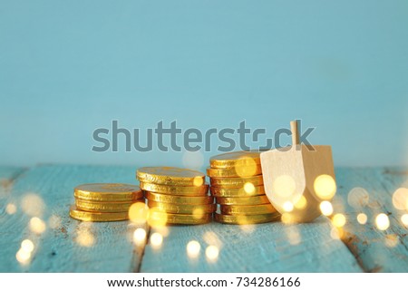 jewish holiday Hanukkah image background with traditional spinnig top and chocolate coins. Glitter overlay