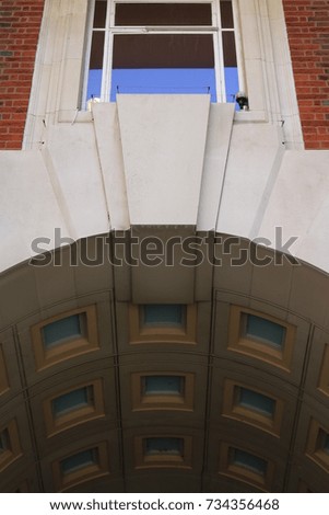 Close up of English bank arch and window. Stone archway and window from an English bank building.