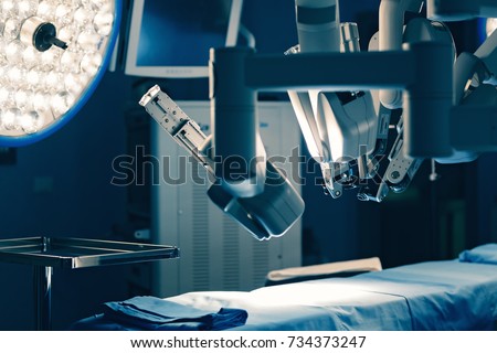 Surgical room in hospital with robotic technology equipment, machine arm surgeon in futuristic operation room. Minimal invasive surgical inoovation, medical robot surgery with 3D view endoscopy Royalty-Free Stock Photo #734373247