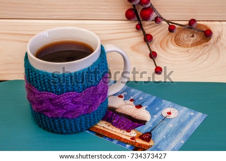 Postcard with beautiful picture, large bright tea cup and christmas wooden snowflakes
