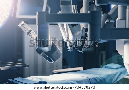 Surgical room in hospital with robotic technology equipment, machine arm surgeon in futuristic operation room. Minimal invasive surgical inoovation, medical robot surgery with 3D view endoscopy Royalty-Free Stock Photo #734378278
