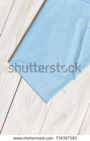 fabric knitwear blue on white wooden background