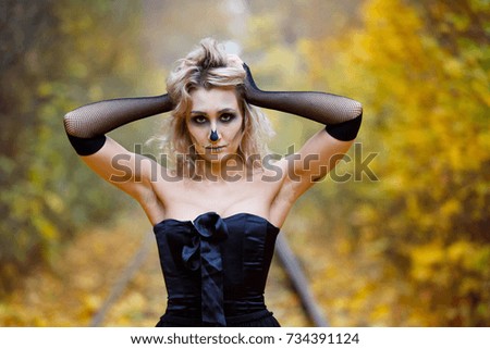 Halloween. Scary portrait of a girl in an autumn forest