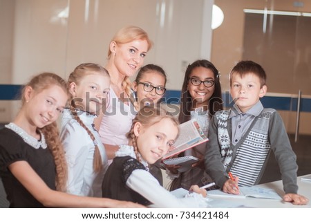 classes in a creative children's school, posing girls, boys and a teacher