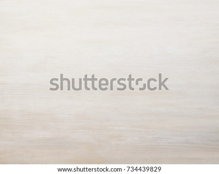 Subtle near white pickled cool tan wood board surface shows subtle grain fade to white