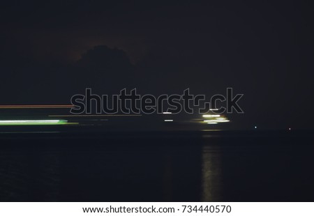 Slow shutter speed. Moving effect.  Blur motion the trading vessel moves at night in the middle of the Straits of Malacca near Port Dickson waters.