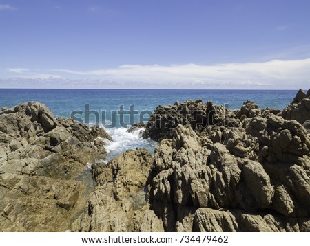 Wave splashing over a rock