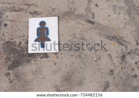 "Female bathroom sign" drop on outdoor concrete floor
