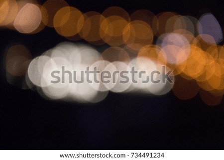 Blured city lights in warm orange and white colors of munich in bavaria unfocused