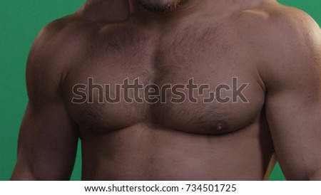 MMA fighter on a green screen. Muscular man on green screen. Green background. Man punching gesture