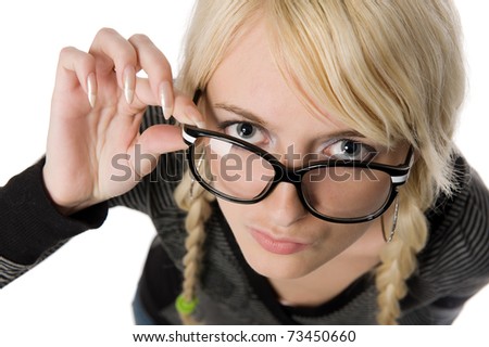 Smart young blond woman with funny glasses and plait looks like nerdy girl. Pose and looking at camera, humor style on white background.