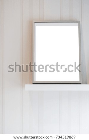 Photo frame on a shelf for home decoration on wooden background
