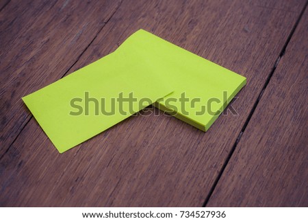 green blank business card mock-up template on wood