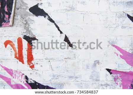 urban exposed brick wall with torn poster Royalty-Free Stock Photo #734584837