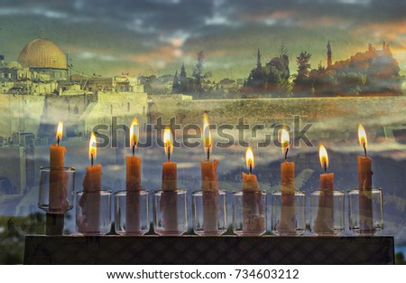 Low key conceptual image symbolizing Jewish holiday of Hanukkah with menorah and burning candles. Background with wailing or western wall in Jerusalem. Selective focus