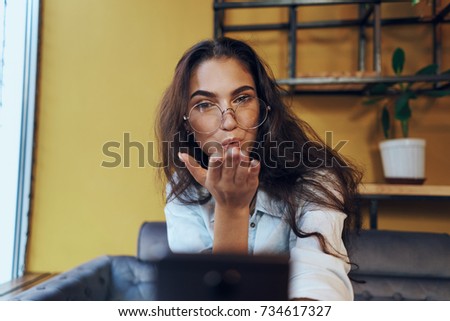  business woman sends an air kiss, laptop, cafe                              