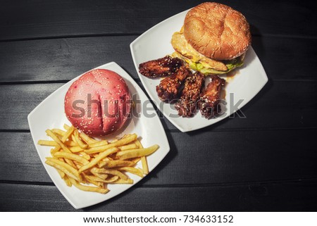 burgers, French fries and chicken in sauce