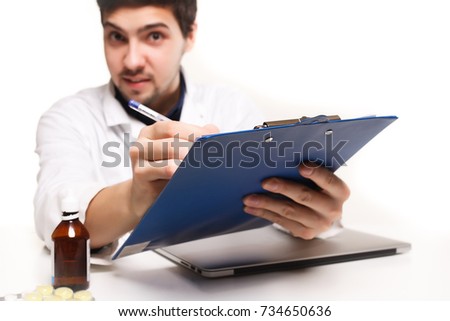 Close-up of doctor's hands writing prescription and holding bottle with pills. Healthcare, medical and pharmacy concept.