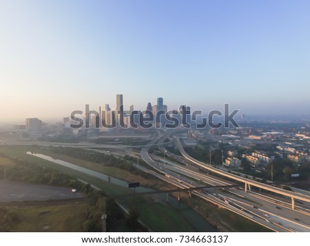 Aerial view of Downtown Houston with Interstate Highway I-10 and I-45 in early foggy fall morning. Seen from Northeast side.
