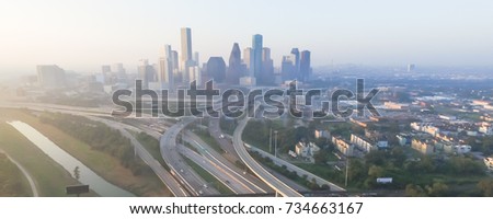 Aerial view of Downtown Houston with Interstate Highway I-10 and I-45 in early foggy fall morning. Seen from Northeast side. Panorama style.