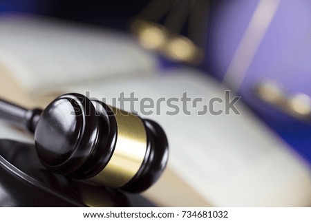 Gavel, scales and book on bokeh background