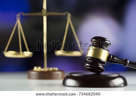 Gavel and scales on bokeh background