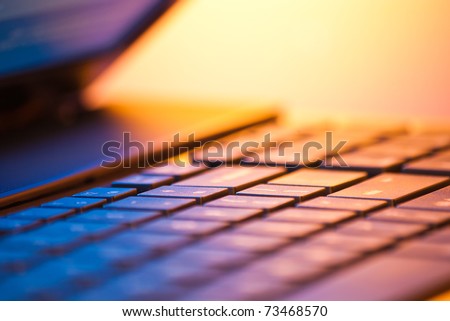 laptop computer detail with copy space and shallow depth of field in warm light Royalty-Free Stock Photo #73468570