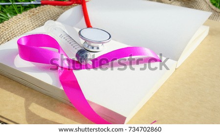 Health care and Medical Concept - Stethoscope and Breast Cancer Awareness Ribbon