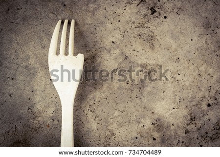 Broken fork on the cement floor 