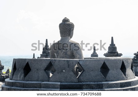 Ancient Buddha statue and stupa at Borobudur temple in Yogyakarta, Java, Indonesia.
