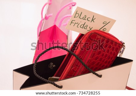 The concept of shopping, paper bags, cards, wallet and tag with the text black Friday