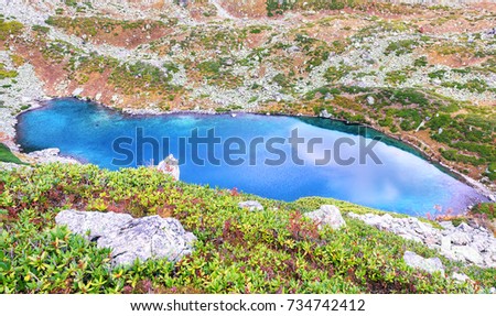 Picturesque autumn view of unique lake. Blue lake in the mountains of Arkhyz. Duchinski lakes.
