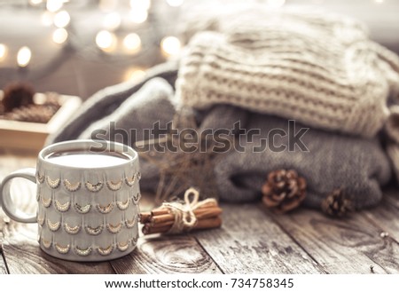 Details of still life in the home interior living room. Beautiful tea Cup and shoes on wooden background . Cosy autumn-winter concept Royalty-Free Stock Photo #734758345