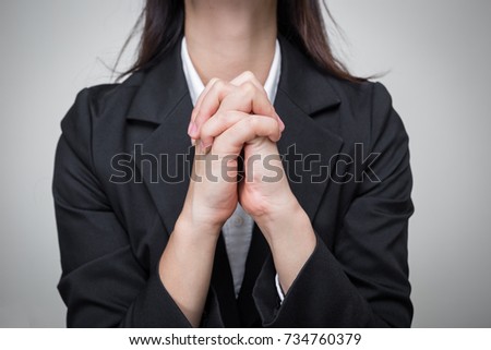 Young business woman join her hand together for praying. 