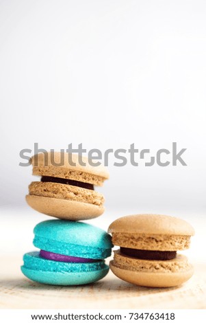 stack of Vibrant colorful macarons on white wooden table. Text space