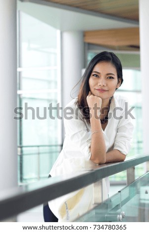 Asian business female is standing  smart with smile in workplace