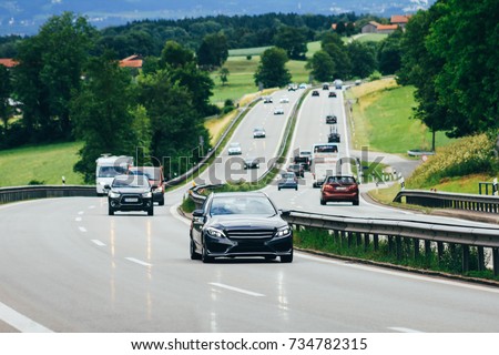 Highway cars and countryside Royalty-Free Stock Photo #734782315