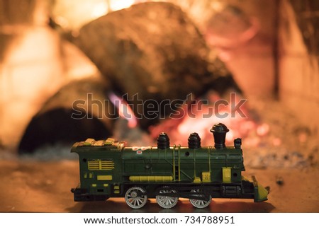 Toy train on the background of fire
