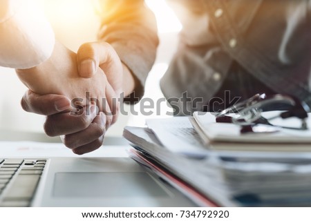 Close up of Business people shaking hands, finishing up meeting, business etiquette, congratulation, merger and acquisition concept Royalty-Free Stock Photo #734792920