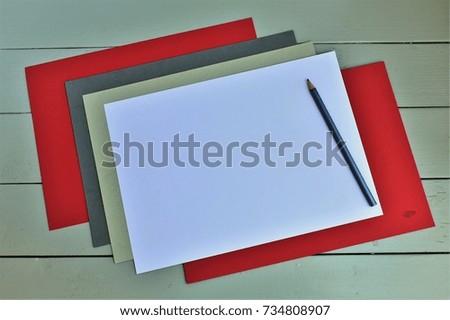 Colored sheets of paper and pencil