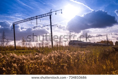 high-speed train among dry autumn grass