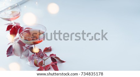 image of two glasses of red champagne on white background 