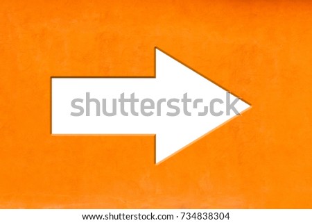White arrow carved on vivid bright orange color empty rustic background texture.