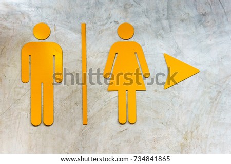 front of toilet or restroom with sign or symbol of Man and Women