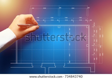 Focused caucasian architect working at drawing touch board with hand at office. Floor plan, busy, concentration concept