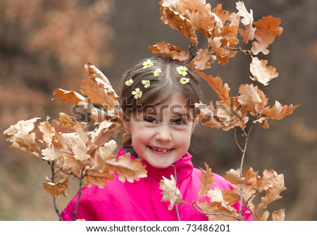 Beautiful little girl with primrose in hair