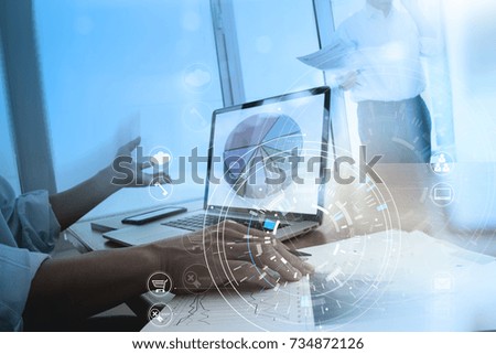 Hands of businessman using mobile phone in modern office with laptop and digital tablet computer in team meeting with VR icon diagram
