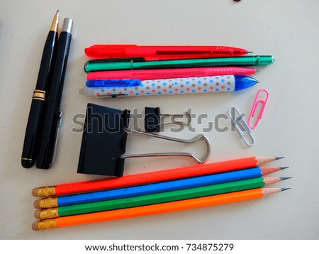 stationery set of pen, pencil, paper clips on white working desk. Education concept.