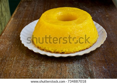 Closeup on quindim, a tasty yellow Brazilian dessert made with condensed milk and eggs on grunge wooden table
 Royalty-Free Stock Photo #734887018